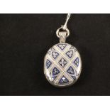 A white metal locket with chased and blue and white enamel decoration