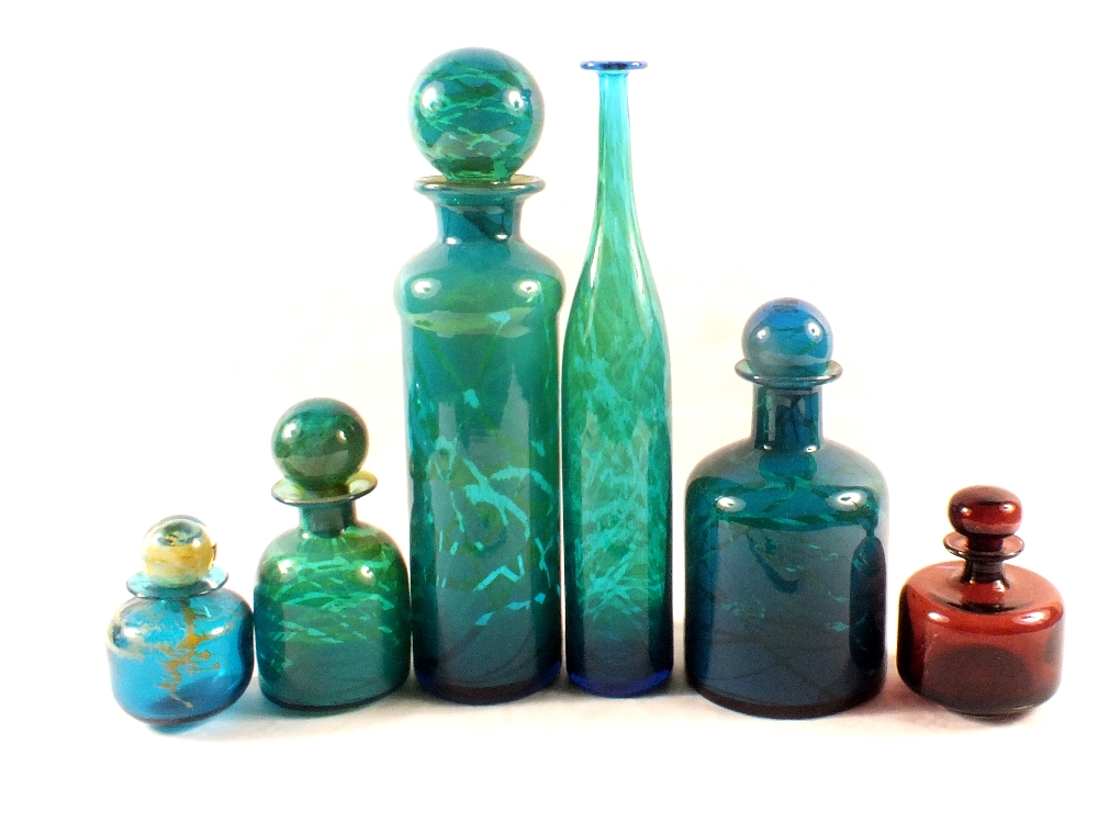 Five pieces of Mdina glass lidded bottles in varying patterns plus one other tall vase,