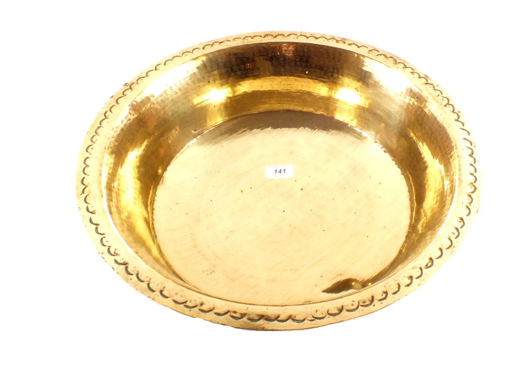 An early 19th Century deep brass dairy bowl with punch decorated rim,