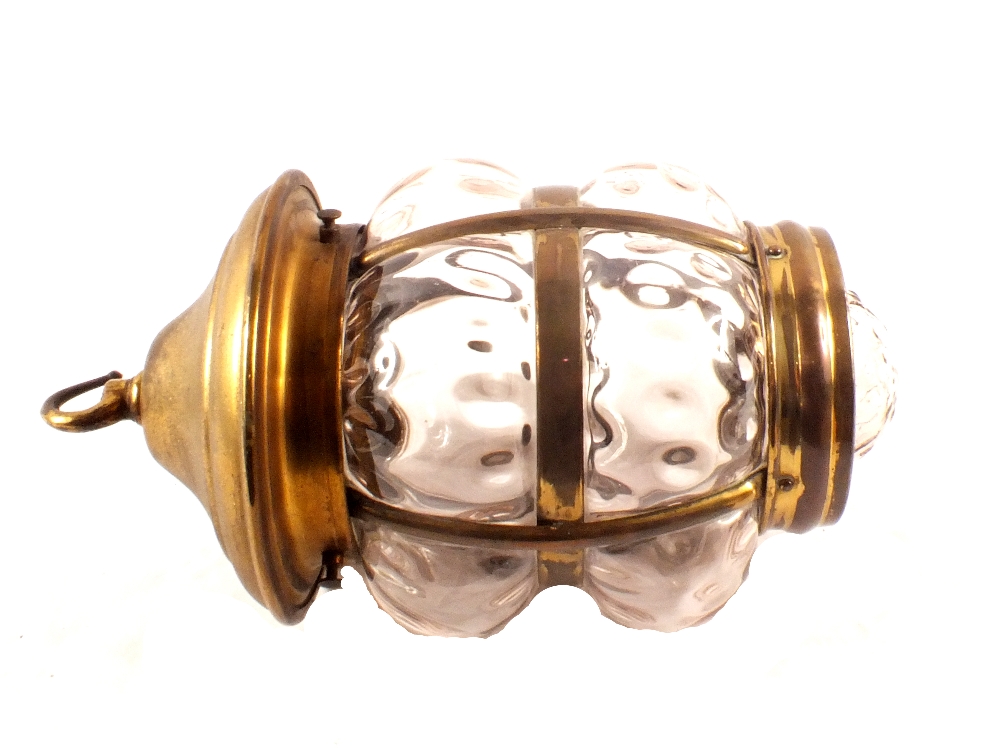 An early 20th Century brass and bulbous glass hanging lantern,