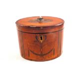 A Sheraton period oval mahogany tea caddy with cross banding and stylised leaf inlays (some veneer