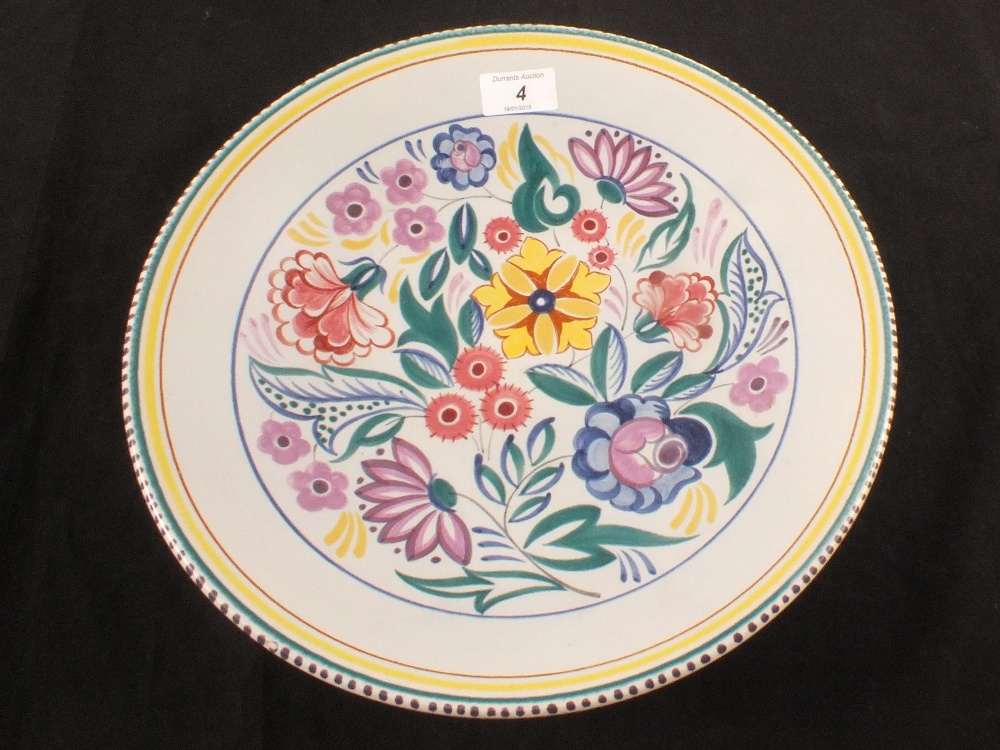 A Poole floral charger, marked X/CS,