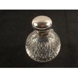 A silver top cut glass scent bottle