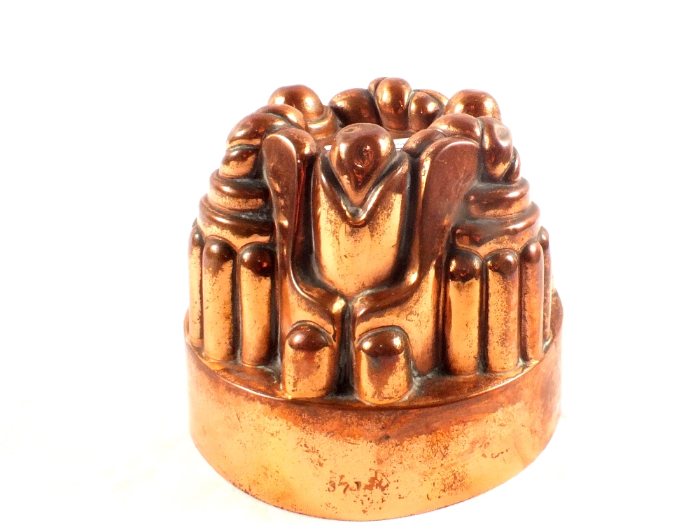 A Victorian circular copper jelly mould of turret form and stamped '371',