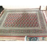 Two machine made Persian pattern rugs plus a circular Indian floral rug