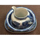 A blue and white jug and bowl plus a Willow pattern meat plate