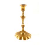 An 18th Century brass petal base candlestick