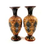 A pair of Doulton Lambeth stoneware vases with floral decoration, dated 1886,