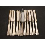 Eleven silver handled knives (as found)