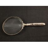 A silver handled magnifying glass