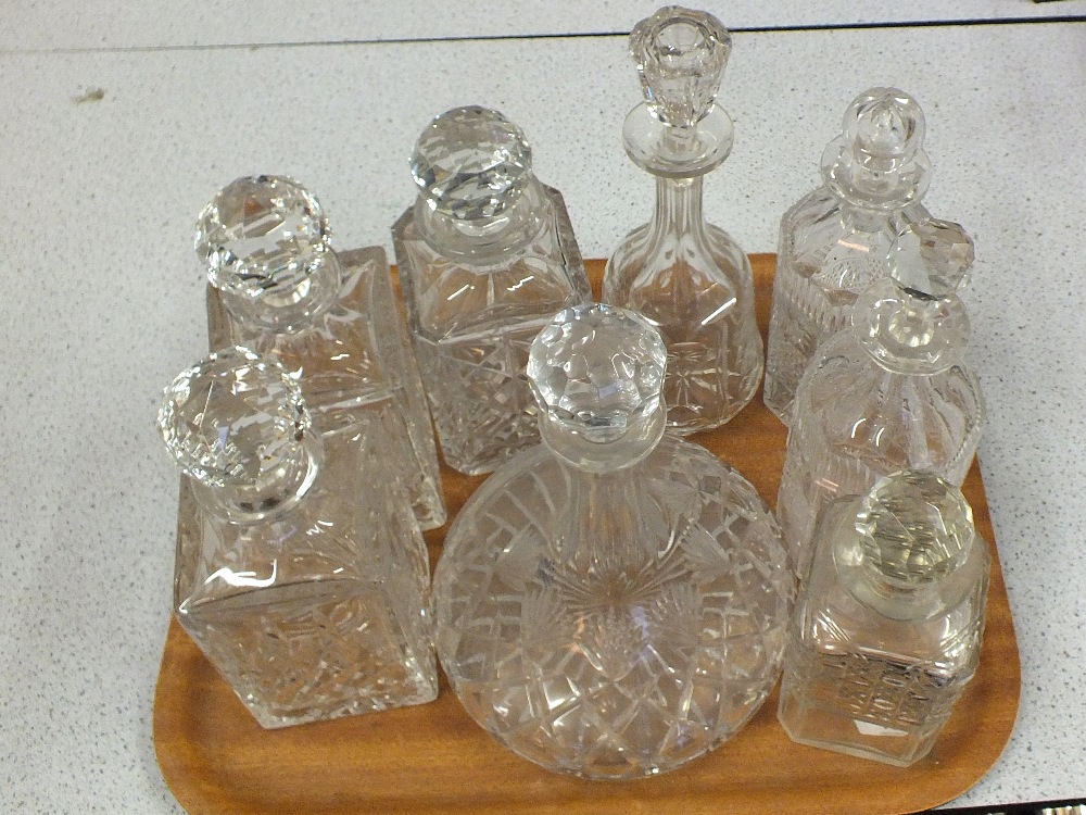 A set of three cut glass decanters plus four others