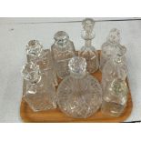 A set of three cut glass decanters plus four others