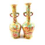 A pair of Chinese polychrome narrow neck vases with dragon and floral decoration,