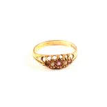 A 9ct gold ring set with white and purple stones,