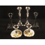 A pair of pewter candlesticks, a pair of silver candlesticks (as found),