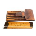 A leather cased seven piece wood and brass hogshead measure by J.