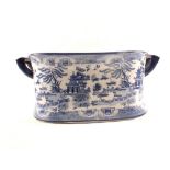 A blue and white Willow pattern footbath