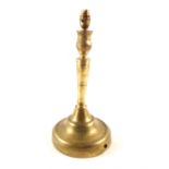 A large 18th Century continental brass candlestick on wide circular base, 13 1/2" high,