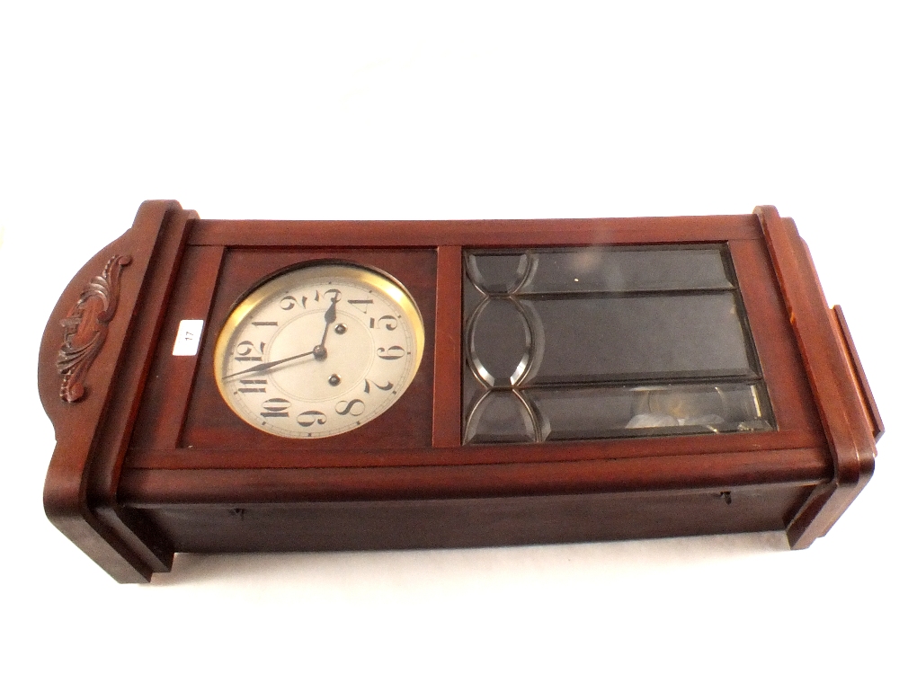 A mahogany striking wall clock