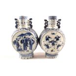 A matched pair of 19th Century Chinese blue and white moon flasks depicting children at play and