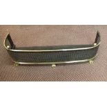 A 19th Century brass and fretted steel fender on three feet,