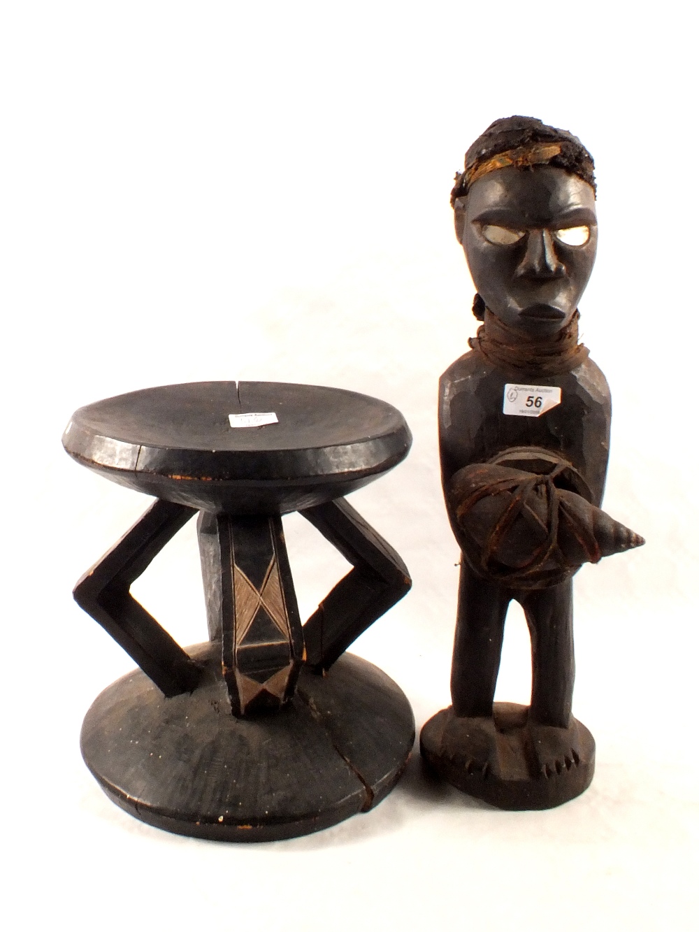 A Congolese stool plus a tribal figure with back pack and carrying a shell,