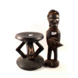 A Congolese stool plus a tribal figure with back pack and carrying a shell,