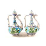 A pair of Indian pottery turquoise and coloured ewers