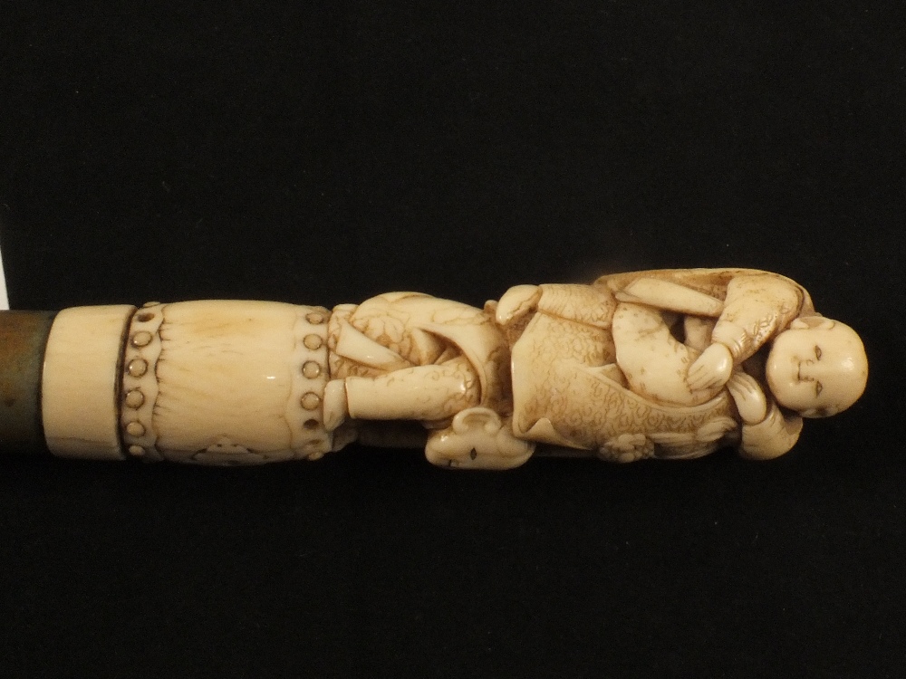 A Japanese bamboo walking cane with bone figural grip