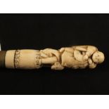 A Japanese bamboo walking cane with bone figural grip