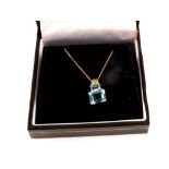 A 9ct gold blue topaz and diamond pendant on 9ct gold chain