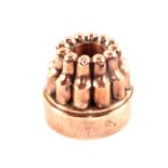 A Victorian copper ring jelly mould with a circle of twelve turrets, stamped 'N22',