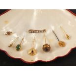 A selection of stick pins, most 15ct or 18ct gold, various styles including bird,