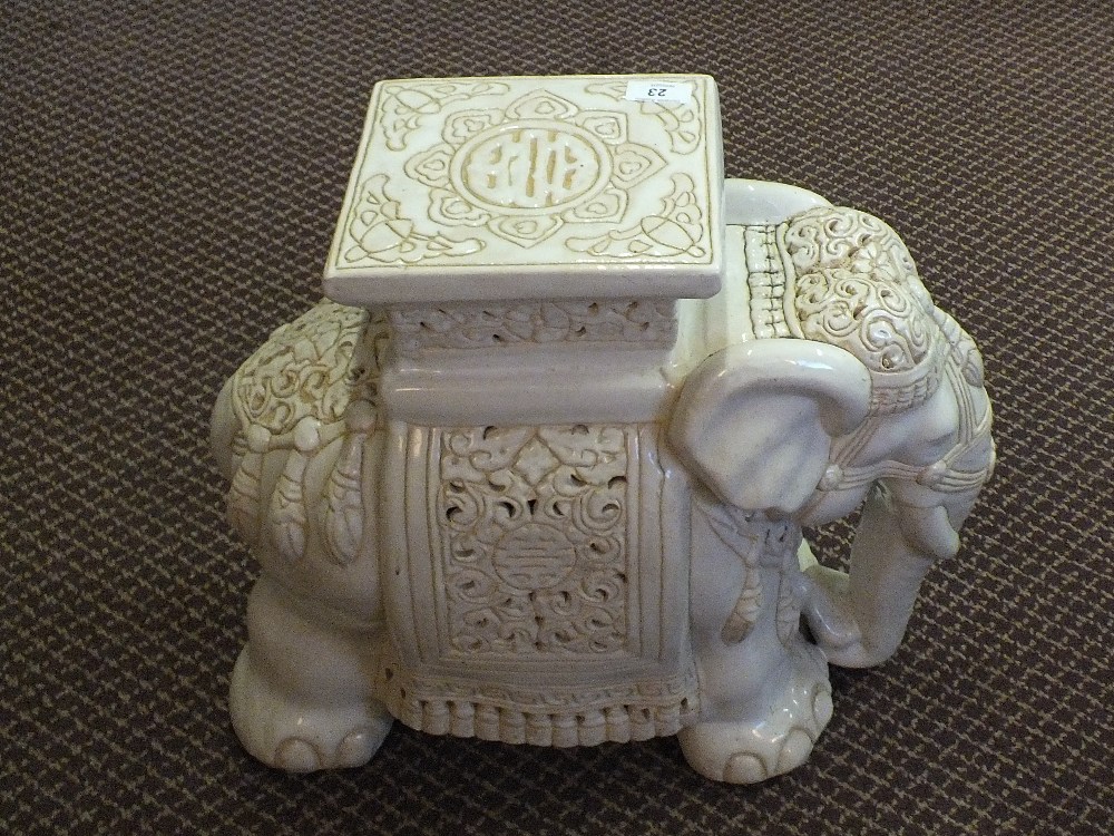 A cream glazed elephant garden seat
