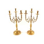 A pair of late 19th Century three branch brass candelabra with scrolling arms,