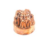 A Victorian circular copper jelly mould of fluted turret form, stamped '562',