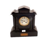A Victorian black marble striking mantel clock