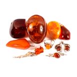 Mixed amber items including silver ring, silver brooches, one in the form of a rose,