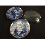 Four German porcelain Delft style blue and white plates plus a glass lens