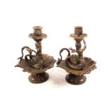 A pair of 19th Century brass candlesticks of cherub form and shell bases,