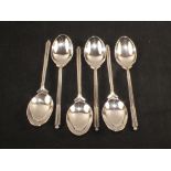 A set of six silver golf themed teaspoons