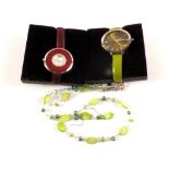Two wristwatches plus a green necklace and earrings