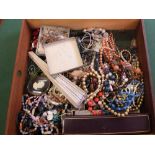 A box of various necklaces and costume jewellery
