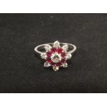 An 18ct white gold ruby and diamond cluster ring,