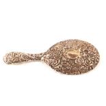 An embossed silver hand mirror,