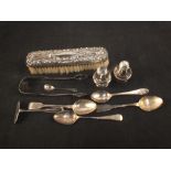 A collection of silver items including spoons, tongs,