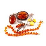 A selection of silver and white metal amber brooches, pendants etc,