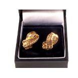 A pair of 10ct gold diamond earrings set with brilliant and baguette cut diamond