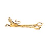 A pair of antique brass scissor candle snuffers cast in the form of a stylised cat