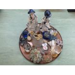 A copper tray containing glass paperweights,